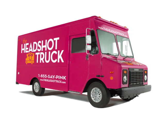 A close-up photo of a pink truck, focusing on the front part of the vehicle.