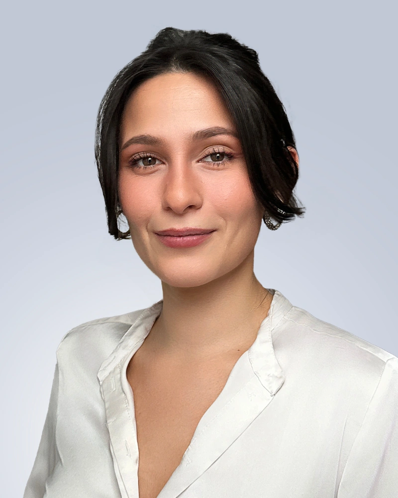 women professional headshot pose with natural expression and gray background