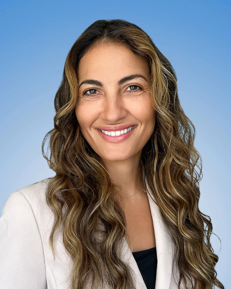 best LinkedIn photo example with genuine smile and professional expression on blue background