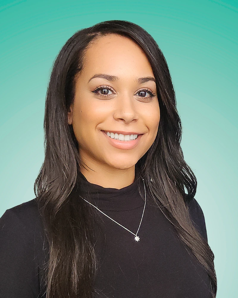 creative industry headshot example with bold teal background showing personality-forward professional styling