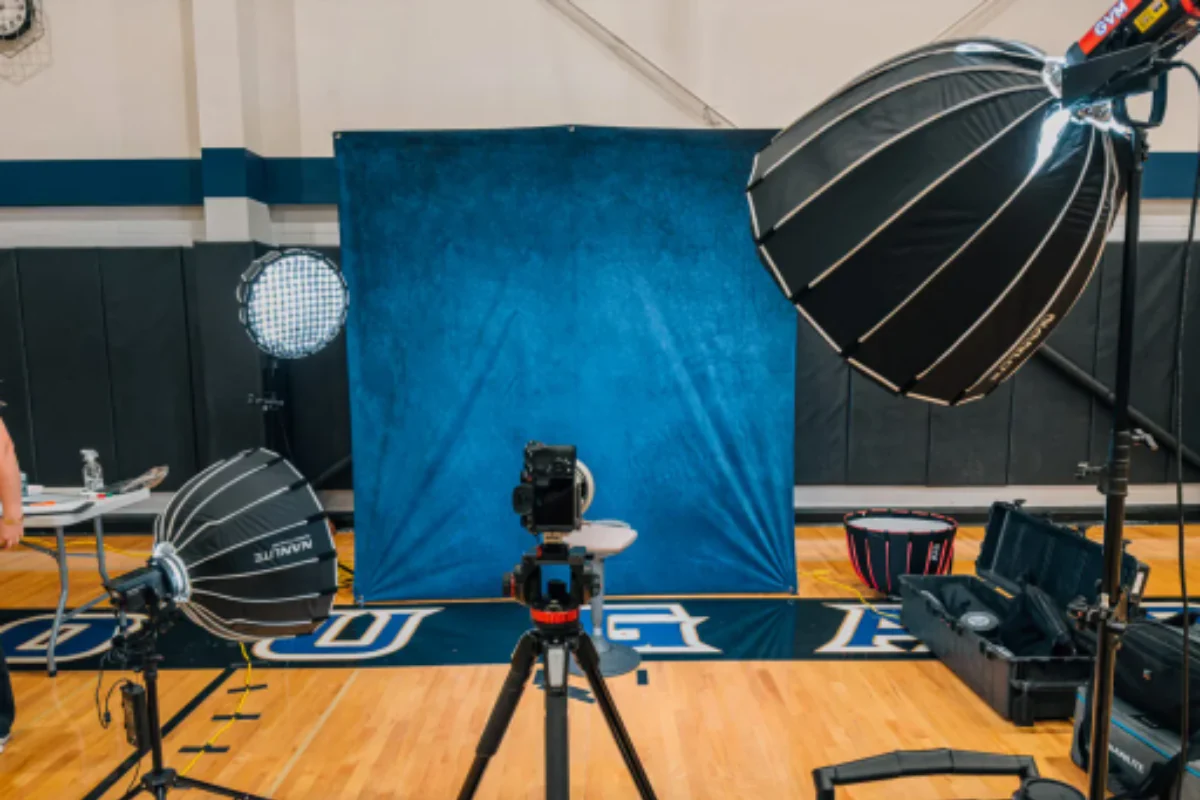 traditional school picture day taking over a gymnasium with equipment and long student lines