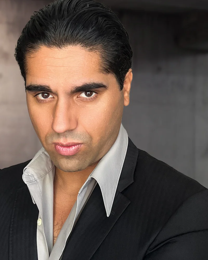 theatrical acting headshot with intense expression and dark background