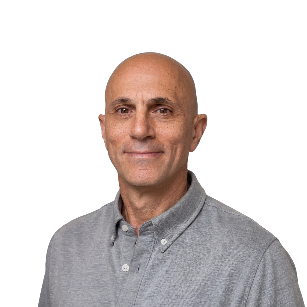2. Male engineer. Middle-aged man with a bald head wearing a grey polo shirt against a blue gradient background. Pure IC energy