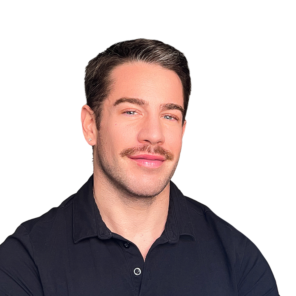 9. Sales VP. Man with a mustache and visible arm tattoos, wearing a black polo shirt, against a solid black background. Tie-less but structured