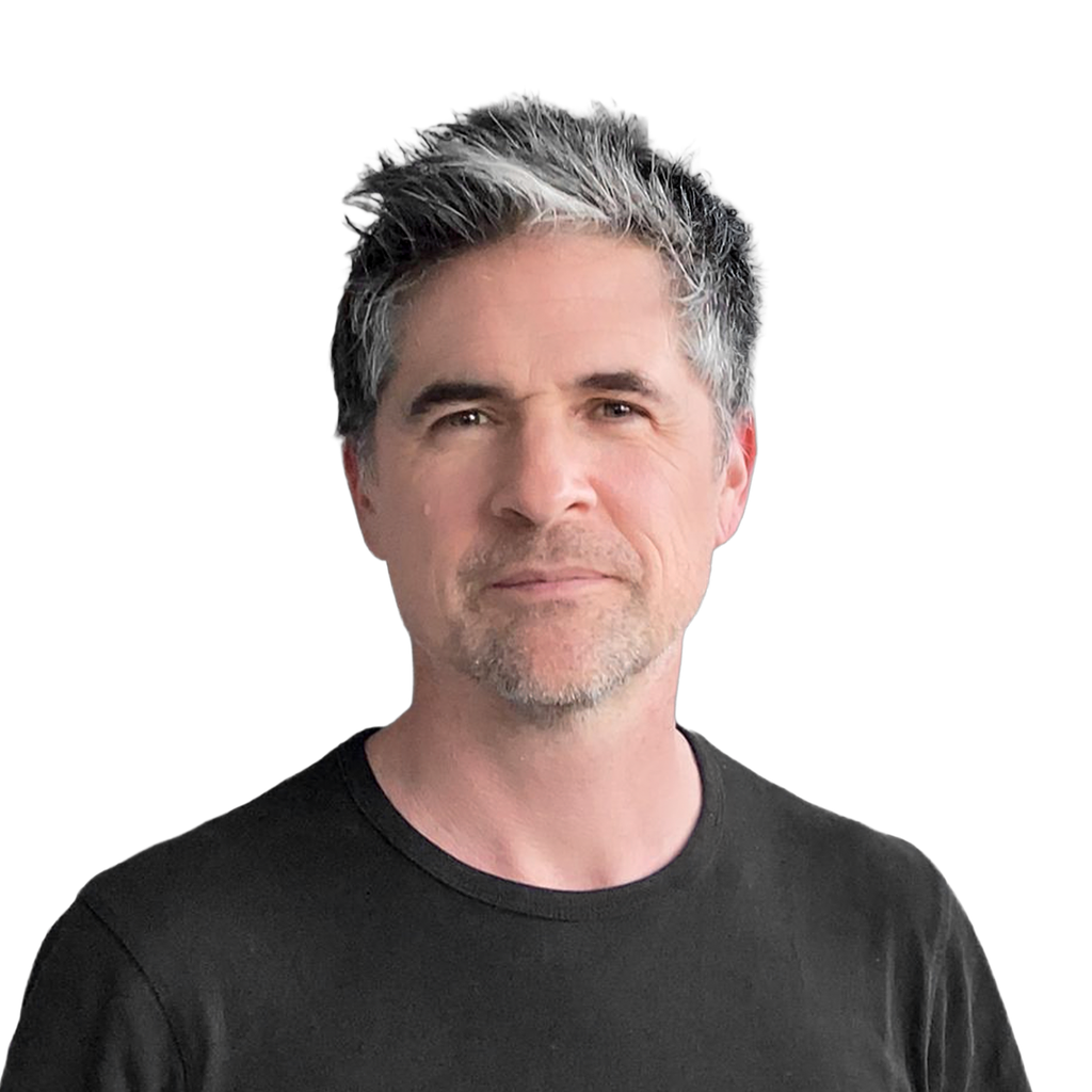 10. Bootstrapped founder. Portrait headshot of a middle-aged man with salt-and-pepper hair wearing a black t-shirt against a solid black background