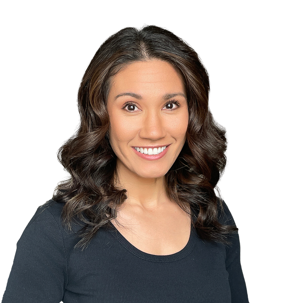 14. Behavioral health therapist. Smiling woman with dark, wavy hair wearing a black ribbed top against a solid black background