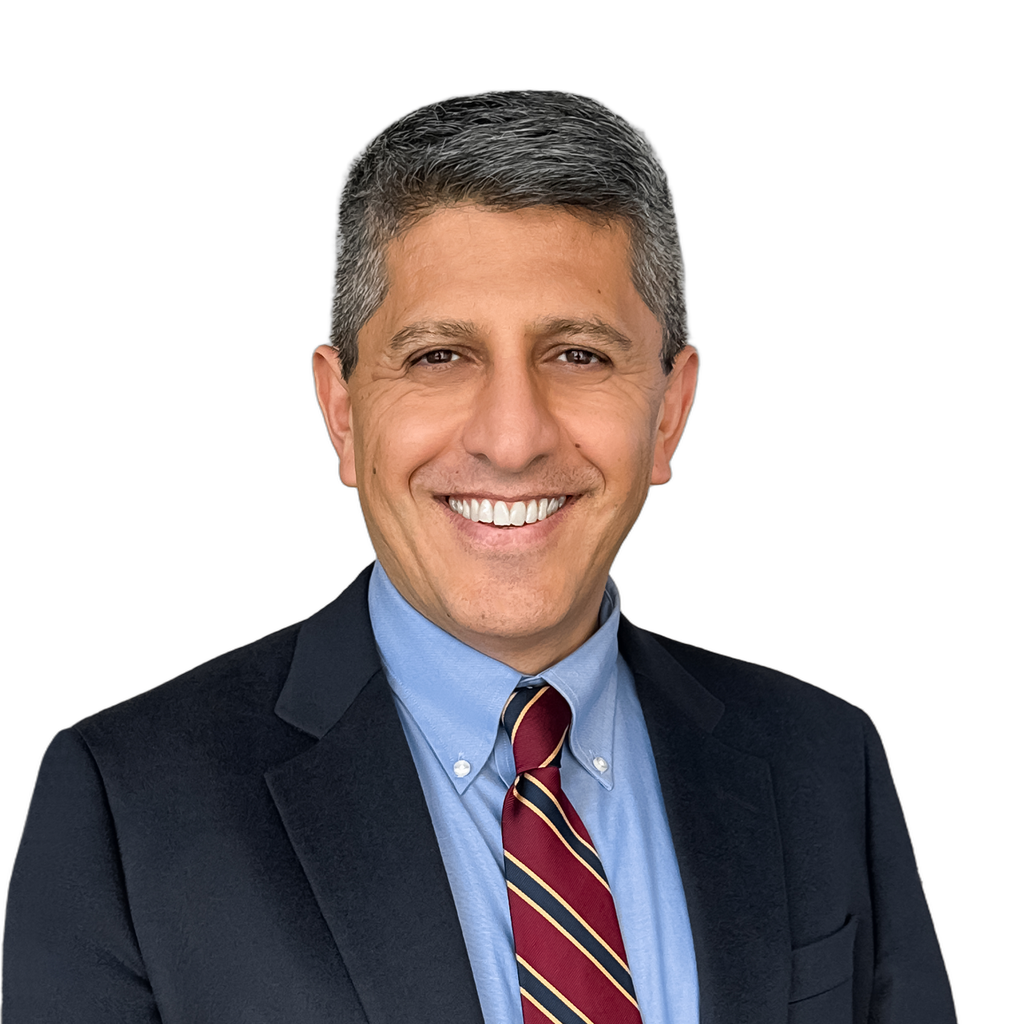 21. Wealth advisor. Smiling middle-aged man in business formal attire against a plain white background. Advisor work tunes slightly warmer than IB