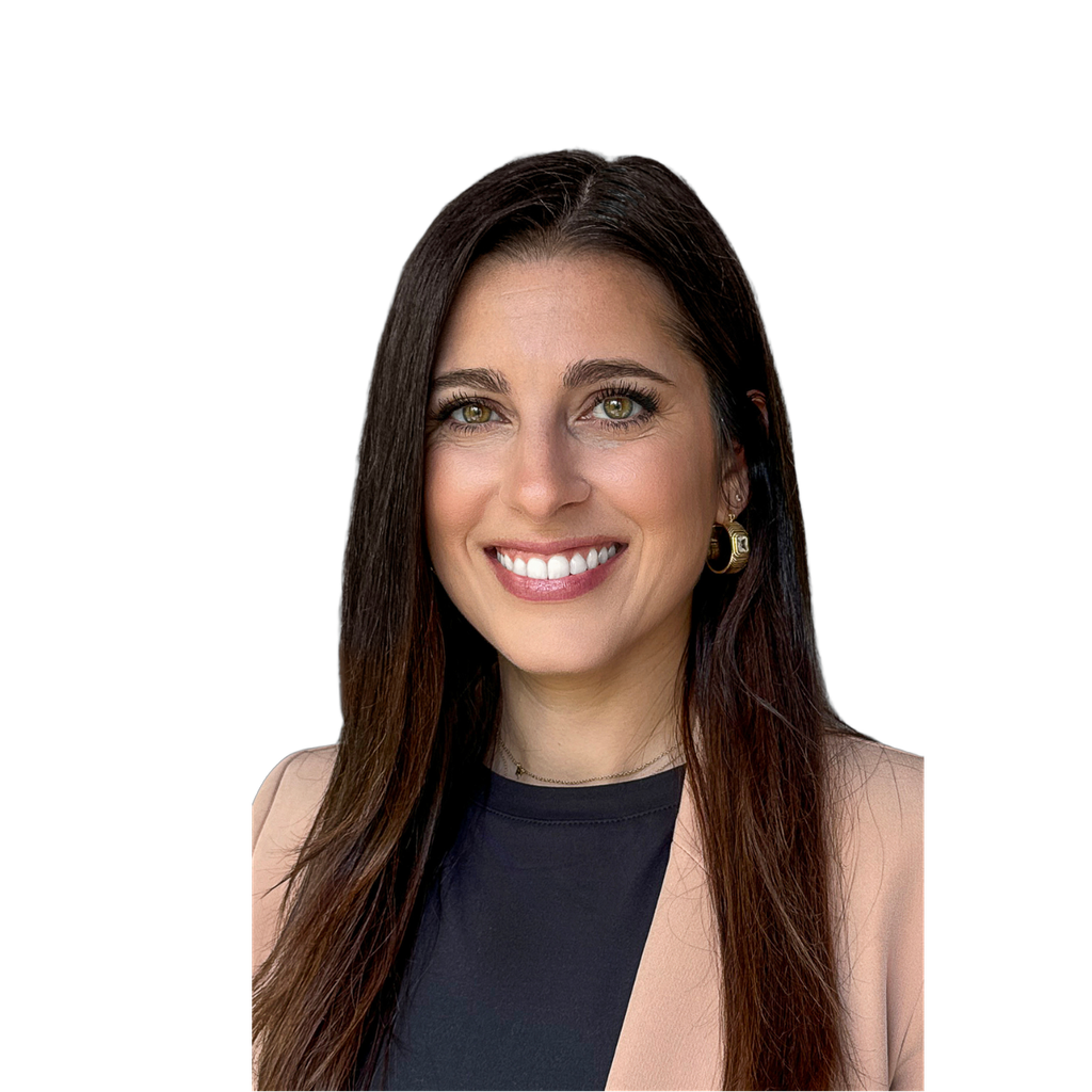 23. Female CFO. Smiling woman with long dark hair and a blazer against a light blue-grey background. Senior framing on a darker background
