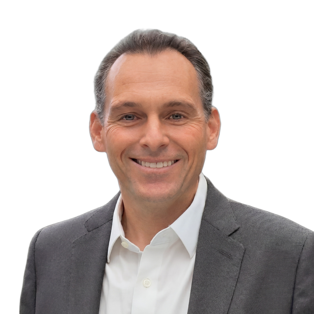 30. IP boutique founder. Middle-aged man in a grey blazer and white shirt against a clean, light gray background. Sleek-modern