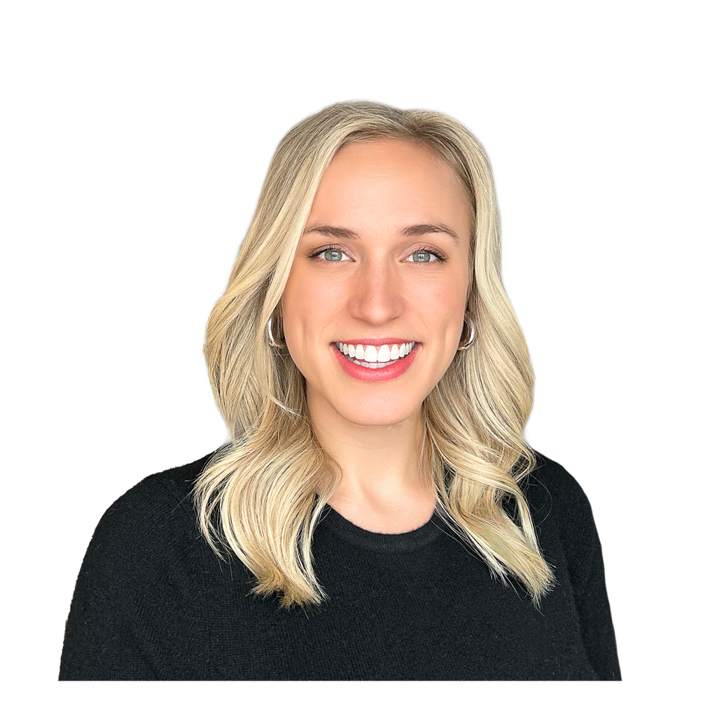 46. Agency founder. Smiling blonde woman wearing a black sweater against a solid black background